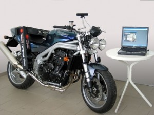 A motorbike next to a laptop